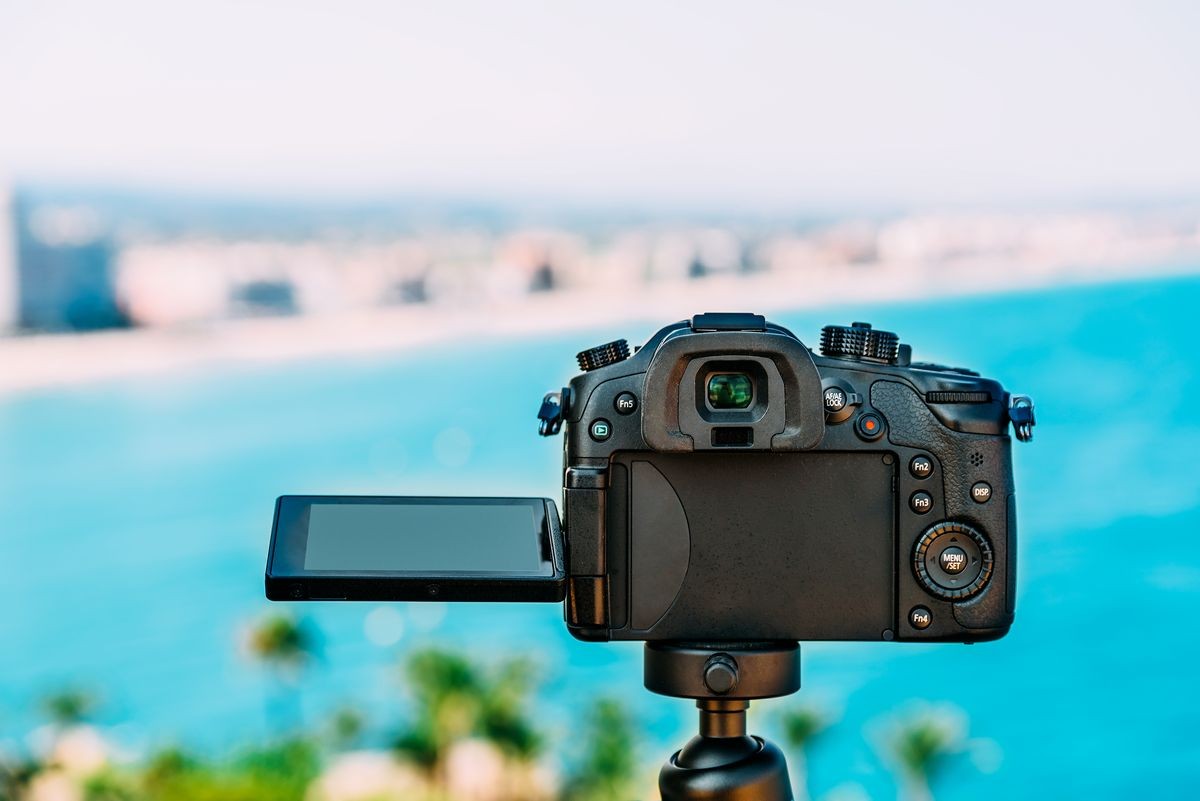 Taking Photos With Professional Digital Camera Of City Skyline And Sea Landscape